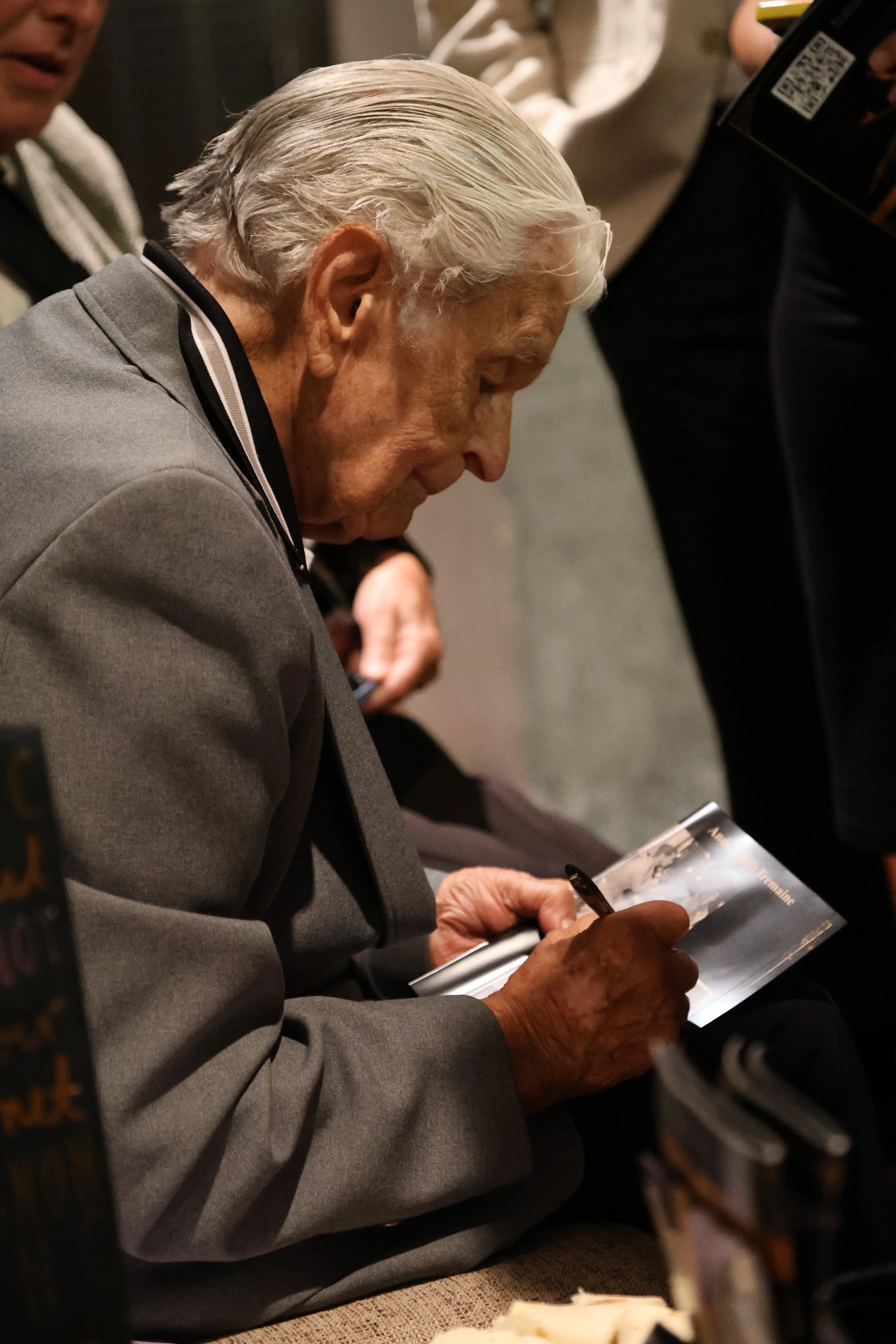 Andrei Tremaine signing an autograph at the centennial gala